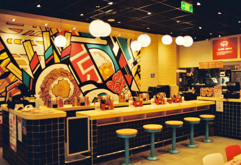 Interior of Dave's hot chicken restaurant with warm lighting and rustic decor